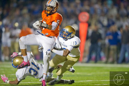North Cobb's Torrance McGee (5) breaks a tackle by McEachern's Rahmoi Parsons (31) and Christian Ford (13) to score a touchdown on Friday, October 18, 2013. 