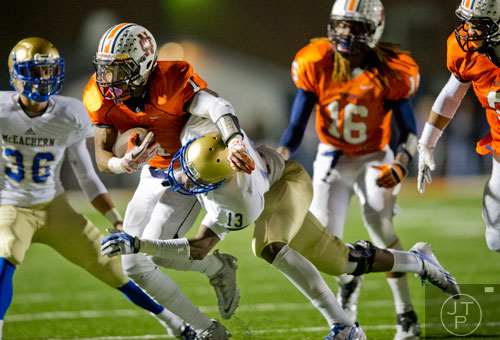 North Cobb's Latrell Gibbs (1) is pushed towards the sideline by McEachern's Christian Ford (13) as he carries the ball up the field on Friday, October 18, 2013.