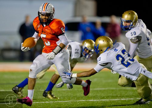 North Cobb's Torrance McGee (5) breaks a tackle by McEachern's Tyler Woodley (23) opening up the field to score a touchdown on a kickoff return on Friday, October 18, 2013. 
