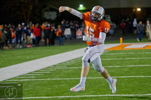 North Cobb's quarterback Tyler Queen (15) throws his hand in the air as he runs off the field after defeating McEachern 28-26 on Friday, October 18, 2013. 
