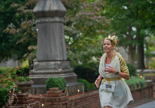 Cheryl Williams runs through Oakland Cemetery in Atlanta during the 2013 Run Like Hell 5k on Saturday, October 19, 2013. 