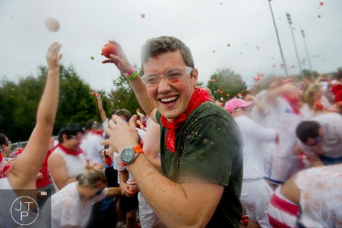 Brian McArthur looks for his next target as thousands of people hurl tomatoes at each other during the Tomato Royale portion of the Great Bull Run at the Georgia International Horse Park in Conyers on Saturday, October 19, 2013. 