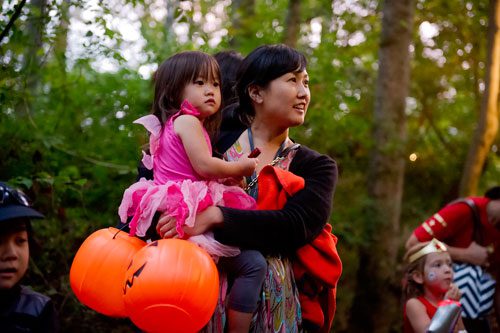 Misae Okada (right) holds her daughter Kano as they walk the trails at the Chatthoochee Nature Center in Roswell during a Halloween Hike on Saturday, October 19, 2013.