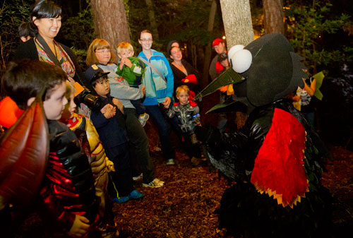 Dressed as a red winged balckbird, Joey Giunta (right) entertains a group of hikers as they walk the trails at the Chatthoochee Nature Center in Roswell during a Halloween Hike on Saturday, October 19, 2013.