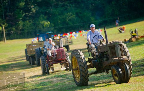 Glenn Still drives one of the tractors in the Tractor Parade at the Still Family Farm in Powder Springs on Saturday, October 5, 2013.