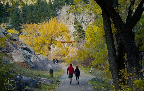 A couple holds hands as they walk the trail next to Boulder Creek on Sunday, October 27, 2013.