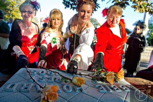 Rosalind Hillhouse (right), Alice Jankowski, Rachel Clarkin and Penny Luck touch the gravestone of Abbie Howard after placing roses on it at Oakland Cemetery in Atlanta on Sunday, November 3, 2013. Hillhouse and the other volunteers were key in raising funds for a gravestone for Howard, who according to some historians was the inspiration for the character Belle Watling in Margaret Mitchell's "Gone with the Wind".  