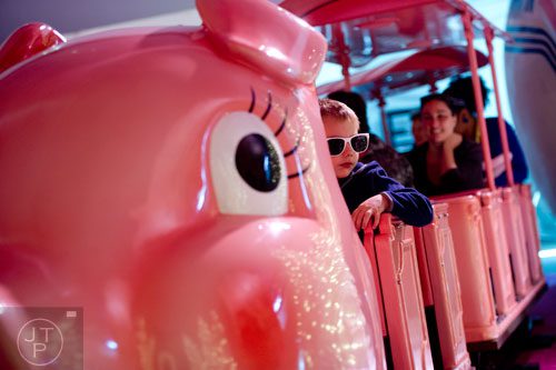 Leonardo Santorelli rides the Macy's Pink Pig at Lenox Square Mall in Buckhead on Saturday, November 2, 2013. 
