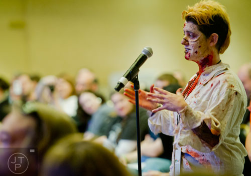 Dressed as a zombie, Lindsay Alvaro asks Greg Nicotero a question during Walker Stalker Con at the Atlanta Convention Center at AmericasMart on Saturday, November 2, 2013. 