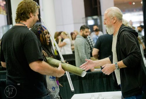 Scott WIlson (right), who plays Hershel Greene on the Walking Dead, shakes hands with Kina Richardson and her husband William during Walker Stalker Con at the Atlanta Convention Center at AmericasMart on Saturday, November 2, 2013.