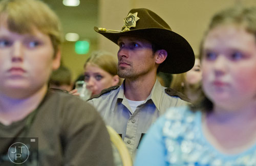 Dressed as Rick Grimes from the Walking Dead, Forrest Ainsworth (center) waits for Andrew Lincoln to come on stage during Walker Stalker Con at the Atlanta Convention Center at AmericasMart on Saturday, November 2, 2013.