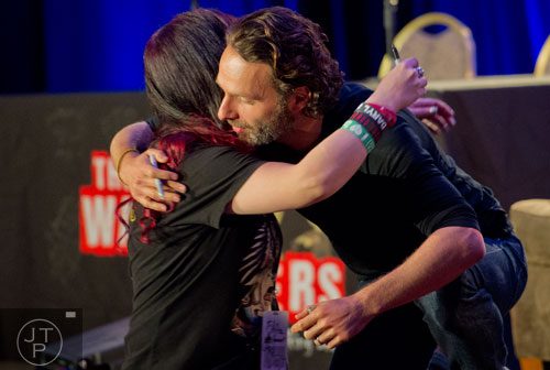 Andrew Lincoln (right), who plays Rick Grimes on the Walking Dead, hugs Afton West after she gave him a dream catcher during Walker Stalker Con at the Atlanta Convention Center at AmericasMart on Saturday, November 2, 2013. 