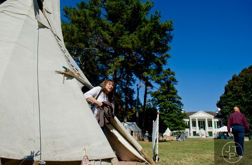 Leilani Plendl exits a teepee during the Indian Festival & Pow-Wow at Stone Mountain Park on Sunday, November 3, 2013. 