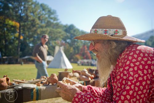 Michael Stuckey (right) works with clay as Steve Handley watches during the Indian Festival & Pow-Wow at Stone Mountain Park on Sunday, November 3, 2013. 