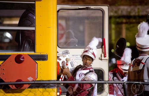 Carver-Atlanta's Alonzo Dillard unloads percussion instruments from the bus before their game against Marist on Friday, November 8, 2013. 