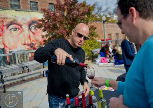 Matt Tinaglia (left) pours a glass of wine for Matt Paproth during the Decatur Wine Festival on Saturday, November 9, 2013. 