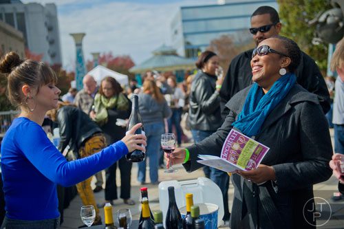 Margo Kemmerer (left) pours a glass of wine for Shauntice Allen during the Decatur Wine Festival on Saturday, November 9, 2013. 