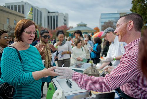 Karen Alcock (left) is given a sample of lobster corn chowder by Brian Gevert during the Decatur Wine Festival on Saturday, November 9, 2013. 