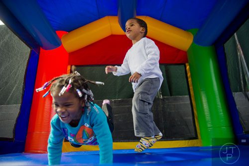 Chance Love (right) and his sister Lauryn jump inside an inflatable bouncey house during the 3rd Annual King of Pops Field Day at Masquerade Music Park in Atlanta on Sunday, November 10, 2013. 
