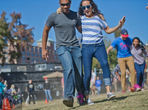 Ivan Garcia (left) and Val Walters compete in a three legged race during the 3rd Annual King of Pops Field Day at Masquerade Music Park in Atlanta on Sunday, November 10, 2013. 