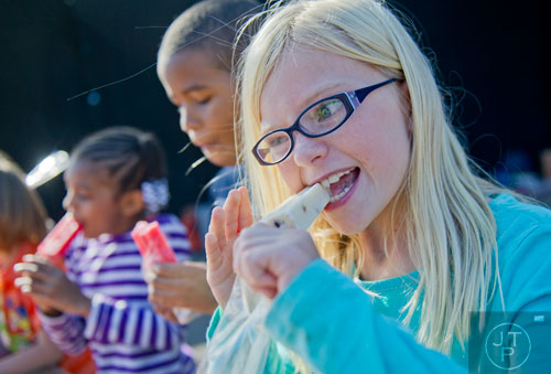 Abigail Cragin (right) participates in the popsicle eating contest during the 3rd Annual King of Pops Field Day at Masquerade Music Park in Atlanta on Sunday, November 10, 2013. 