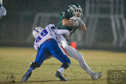 Collins Hill's Rhyan England (7) is tackled by Walton's Ryan LaBan (38) on Friday, November 15, 2013. 