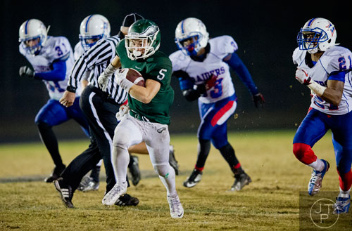Collins Hill's Tyler Henderson (5) runs the ball into the endzone during their game against Walton on Friday, November 15, 2013.
