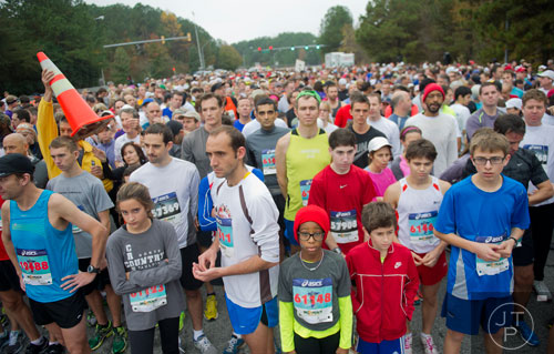 Maddy Dada (center) stands at the starting line with more than 1,800 people for the GA 400 Pay the Last Toll Race in Atlanta on Sunday, November 17, 2013. 