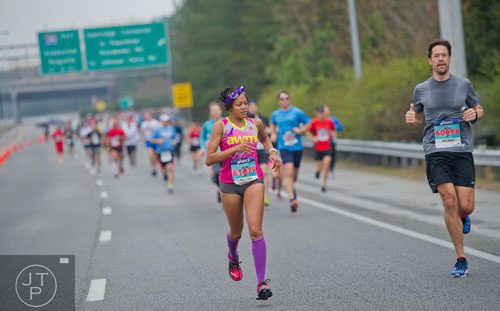 Shawanna White (left) and Chip Hawkins run down 400 during the GA 400 Pay the Last Toll Race in Atlanta on Sunday, November 17, 2013. 