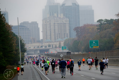 Runners race down 400 during the GA 400 Pay the Last Toll Race in Atlanta on Sunday, November 17, 2013.