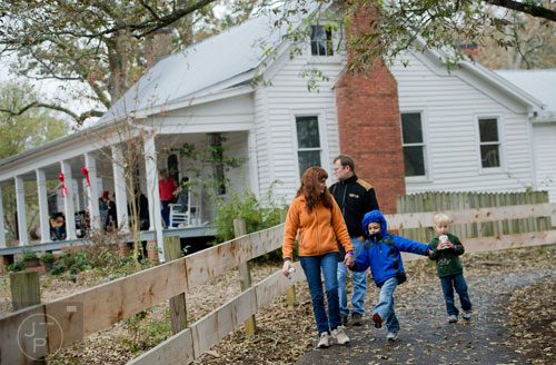 Nancy Berninger (left) holds her son Lukas' hand as they, his father Juergen and Carson Bergquist walk a path during A Civil War Christmas at McDaniel Farm Park in Duluth on Saturday, November 16, 2013. 