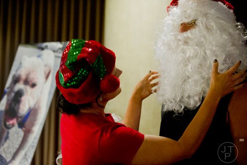 Steve Karp (right) gets help with his beard from his wife Lee before the start of the Georgia English Bulldog Rescue's Santa Paws party at the Westin Buckhead Atlanta Hotel on Sunday, November 17, 2013. 