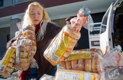 Joan Tatum stacks up packages of bagles at Daily Bread for All in Norcross on Thursday, November 14, 2013. 