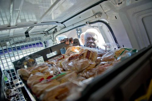 Credo Credolawson unloads a van full of bread at Daily Bread for All in Norcross on Thursday, November 14, 2013. 
