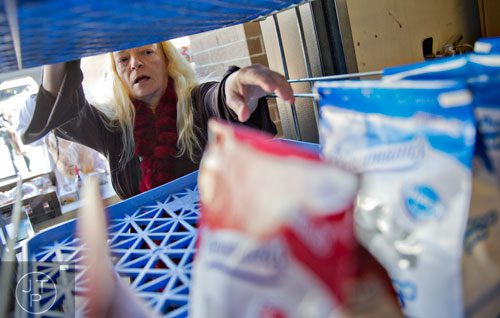 Joan Tatum reaches for a package of doughnuts at Daily Bread for All in Norcross on Thursday, November 14, 2013.