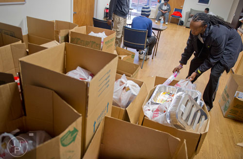 Eric Willie (right) gathers Thanksgiving supplies at the Philip Rush Center in the Edgewood neighborhood of Atlanta on Sunday, November 17, 2013. 