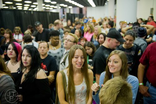 Caleigh Reese (right) and her sister Courtney wait anxiously in line to meet Norman Reedus during Walker Stalker Con at the Atlanta Convention Center at the AmericasMart on Saturday, November 2, 2013.