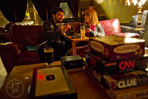 Brandon Schaffer (left) plays a game of Uno with Sierra Travis at Joystick Game Bar in the Old Fourth Ward neighborhood of Atlanta on Saturday, November 2, 2013.