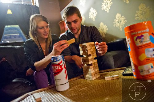 Jessica Jansen (left) plays a game of Jenga with Matthew Clemares at Joystick Game Bar in the Old Fourth Ward neighborhood of Atlanta on Saturday, November 2, 2013. 