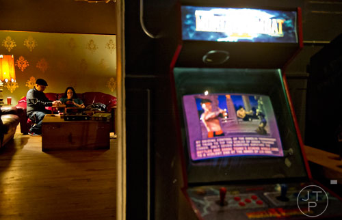 Ivan Lopez (left) plays a game of Uno with Lourdes Mas at Joystick Game Bar in the Old Fourth Ward neighborhood of Atlanta on Saturday, November 2, 2013. 