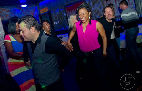Alfredo Piceno (left) teaches a salsa class as Madeline Andrews follows his instructions at the Havana Club in Buckhead on Saturday, November 2, 2013.