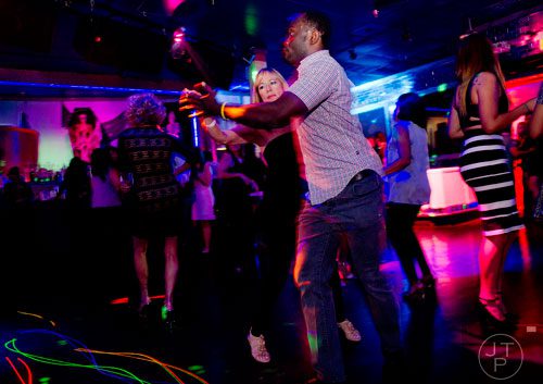 Evangelina Tobin (left) dances with Israel Agaku at the Havana Club in the Buckhead neighborhood of Atlanta on Saturday, November 2, 2013.