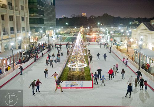 People skate in the open air ice rink at Atlantic Station in Atlanta during the annual Christmas tree lighting on Saturday, November 23, 2013. 