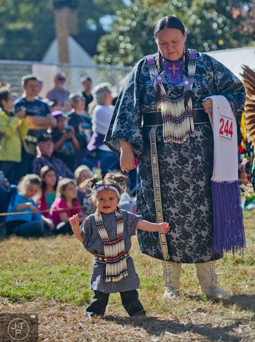 Hollie Stover (right) watches over Ollie Taylor as she dances during the Indian Festival & Pow-Wow at Stone Mountain Park on Sunday, November 3, 2013.