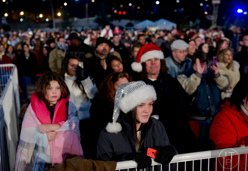 Kaitlyn Lee (center) watches the 66th annual Macy's Great Tree Lighting at Lenox Square Mall in Atlanta on Thursday, November 28, 2013.