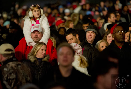 Madelyn Lewis sits on her father Hugh's shoulders to get a better view during the 66th annual Macy's Great Tree Lighting at Lenox Square Mall in Atlanta on Thursday, November 28, 2013. 