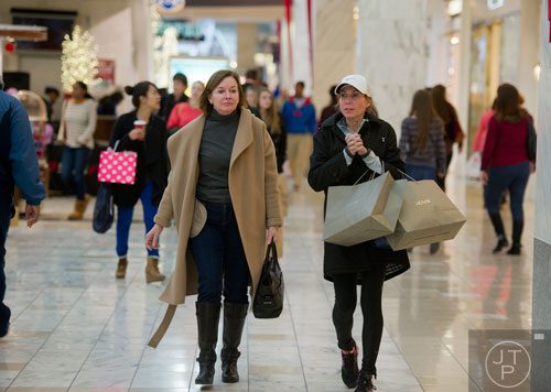 Sally Denton (left) and Jamee Confer walk through Lenox Square Mall in Atlanta as they shop on Friday, November 29, 2013. 