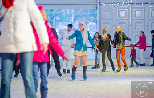 Dressed in costume Amber Montgomery (center) ice skates at Centennial Olympic Park on Sunday, December 8, 2013. 