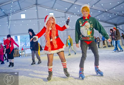 Dressed in costume Maigen Licon (left) and Dave Trinh ice skate at Centennial Olympic Park on Sunday, December 8, 2013.