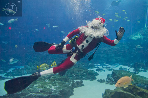 Scuba Claus waves to the crowd at the Georgia Aquarium during an appearance on Friday, December 13, 2013. 